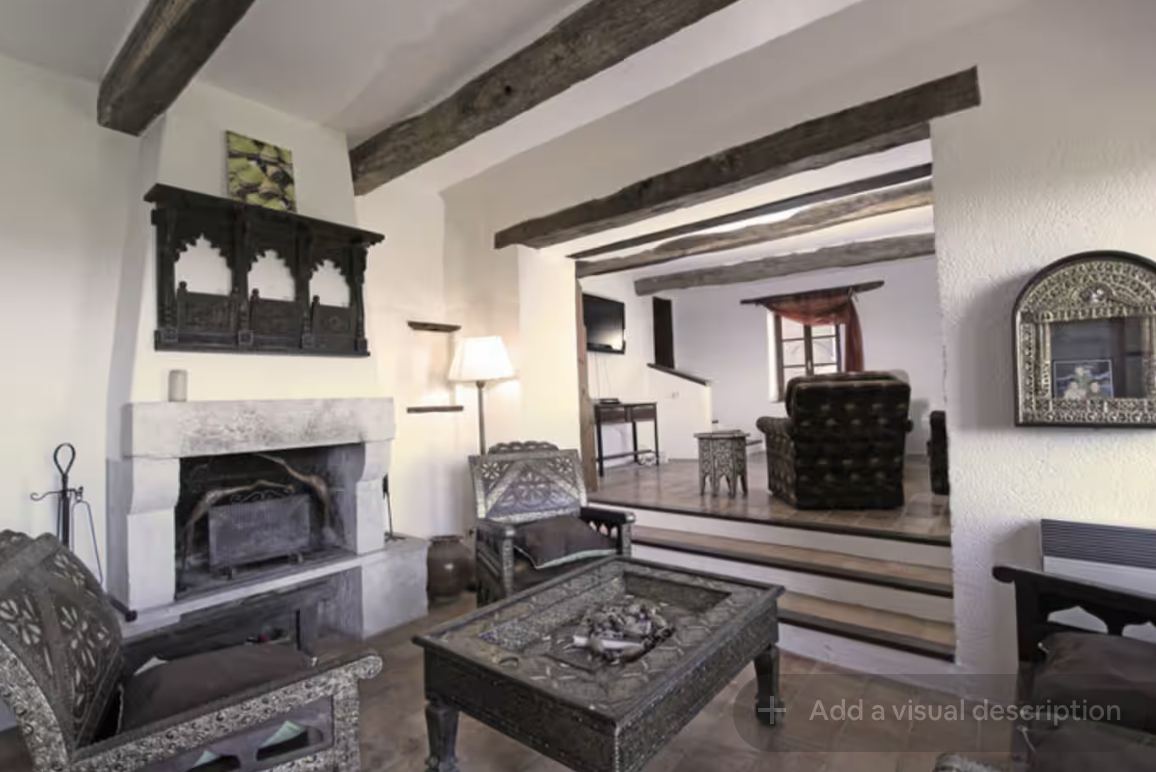 Living room with open fireplace at Mongaudon